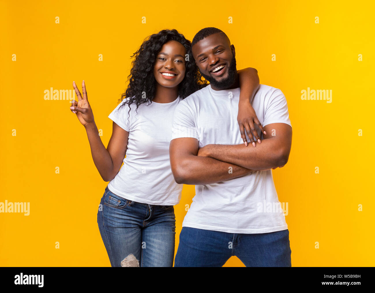 Happy african american woman hugging her man Stock Photo - Alamy