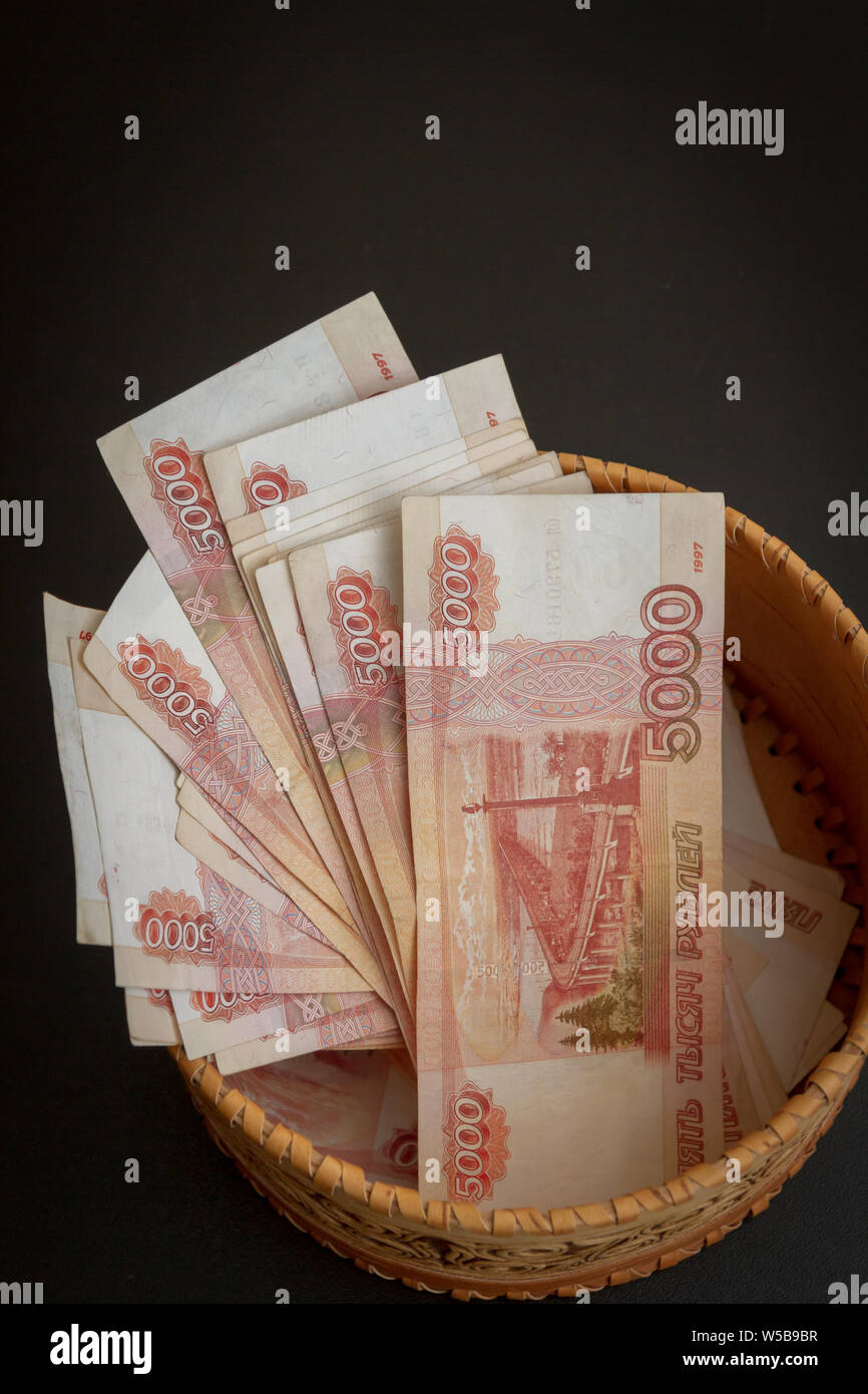 Rubbles R Round A lot of banknotes worth five thousand rubles are in a round wooden ...