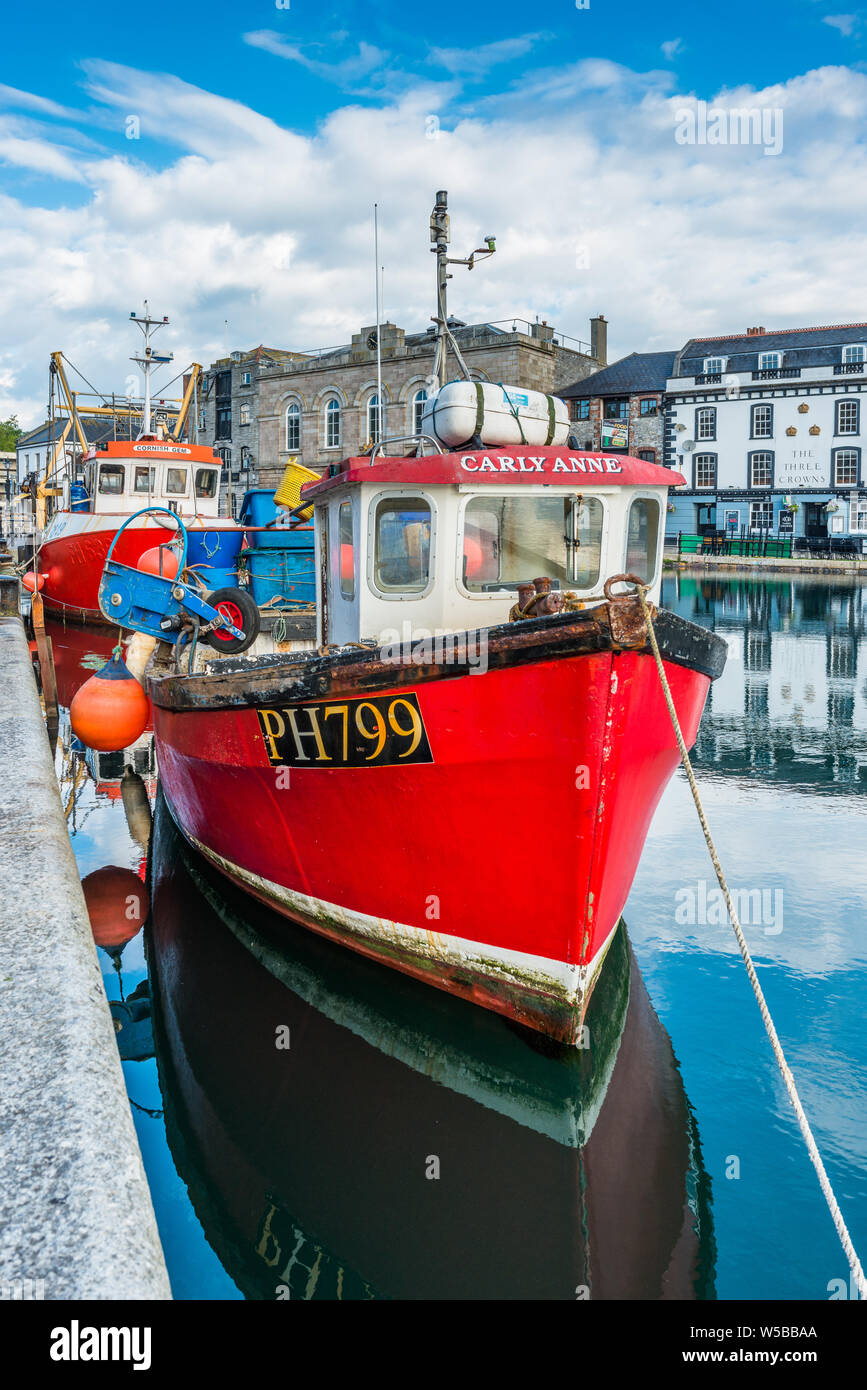 Little red fishing boat at Sutton Harbour, formerly known as Sutton Pool, original port of City of Plymouth at historic Barbican district. Devon. UK. Stock Photo