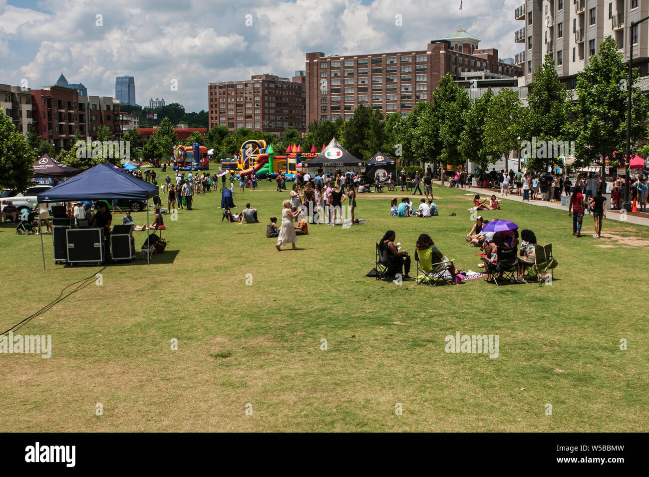 People Enjoy Sitting In The Park And Other Activities At The
