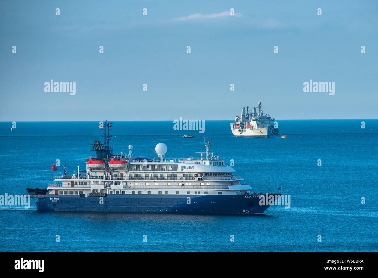 MV Sea Spirit cruise ship shares Plymouth Sound with RFA Fort Victoria of the Royal Fleet Auxiliary. Plymouth, Devon, UK. Stock Photo