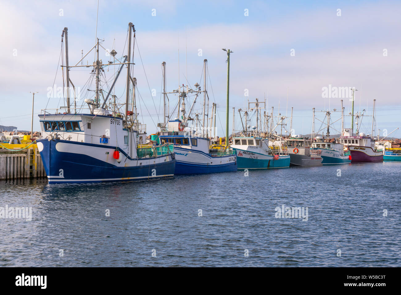 Twillingate, Newfoundland - June 13, 2019: Fishing boats lined up along the dock in the harbor of Twillingate, Newfoundland, Canada Stock Photo