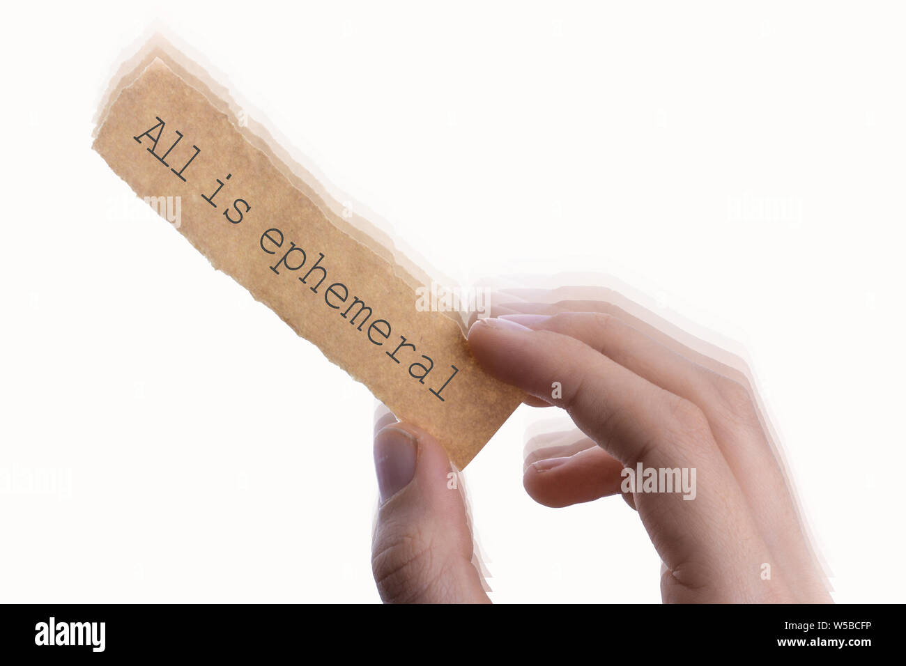 All is ephemeral wording written on torn notepaper in hand Stock Photo