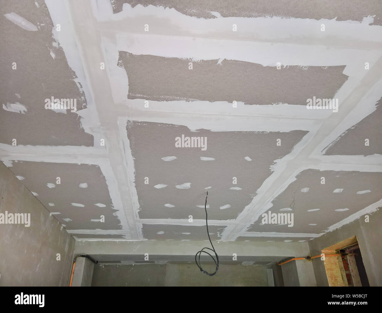 New Sheetrock On The Ceiling In The Reconstructed Room Stock