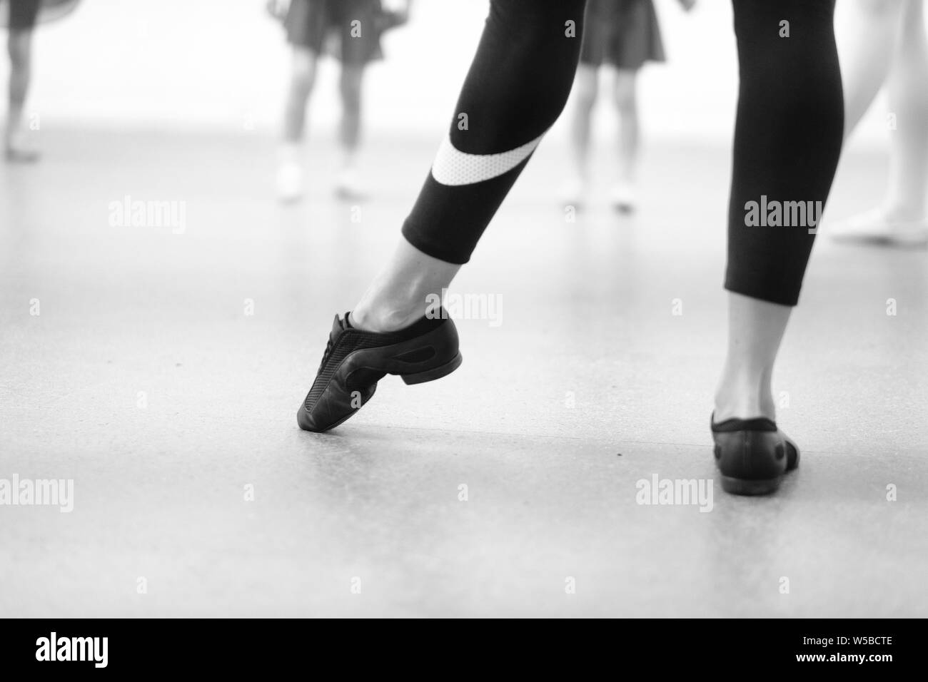 The choreographer shows the children from the dance collective movement with their feet. Stock Photo