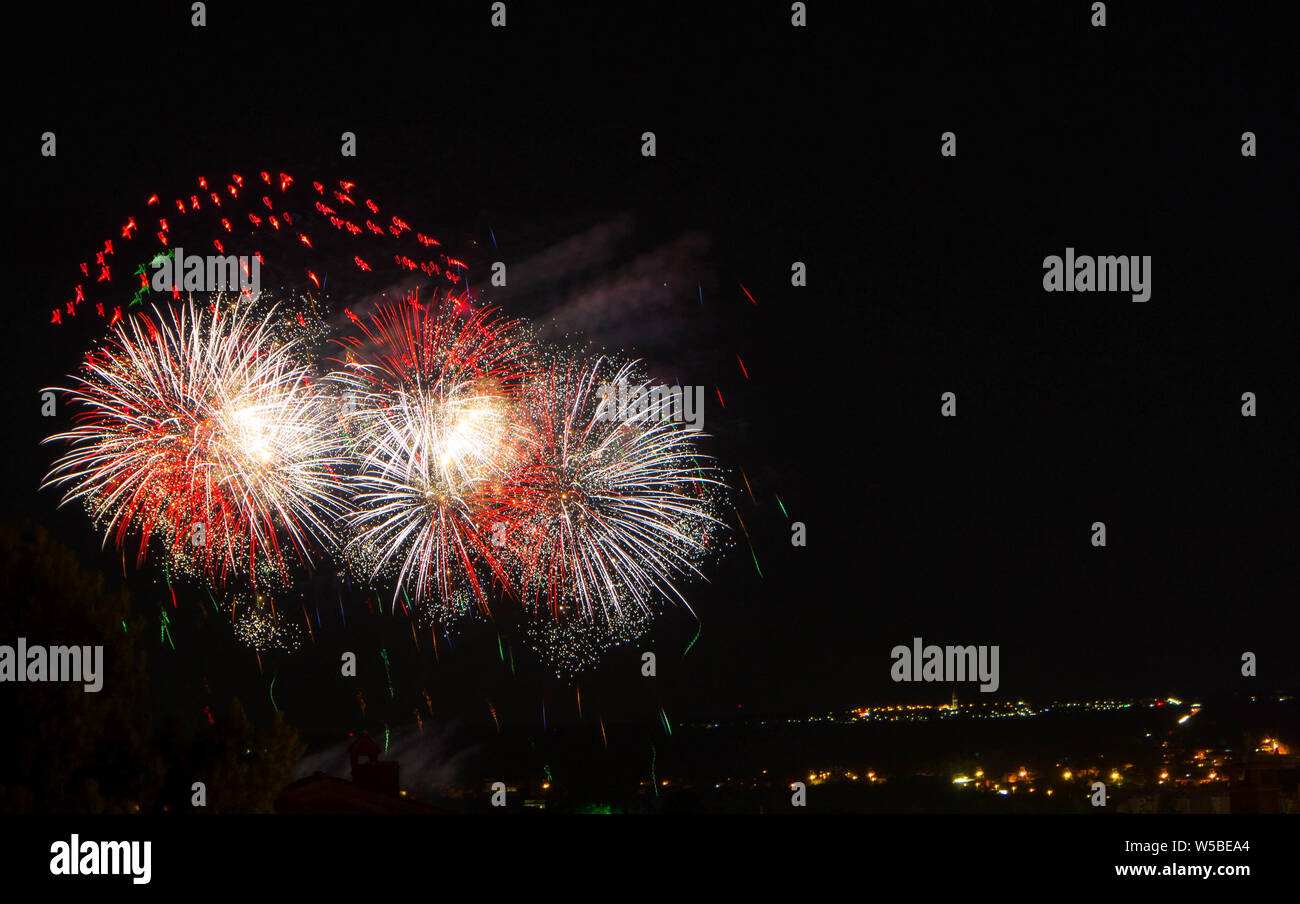 Abstract colored firework against a black background with free space for text Stock Photo