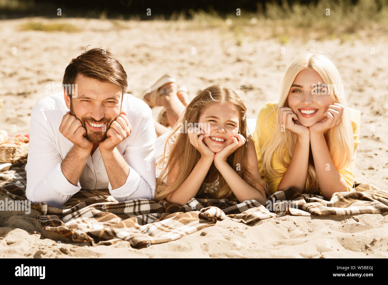 Father, mother and daughter lying on blanket in nature Stock Photo Alamy