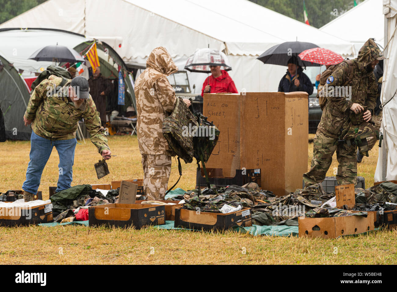 War and Peace Revival 2019, Paddock Wood Hop Farm. People sifting through an Army surplus market stall. Stock Photo