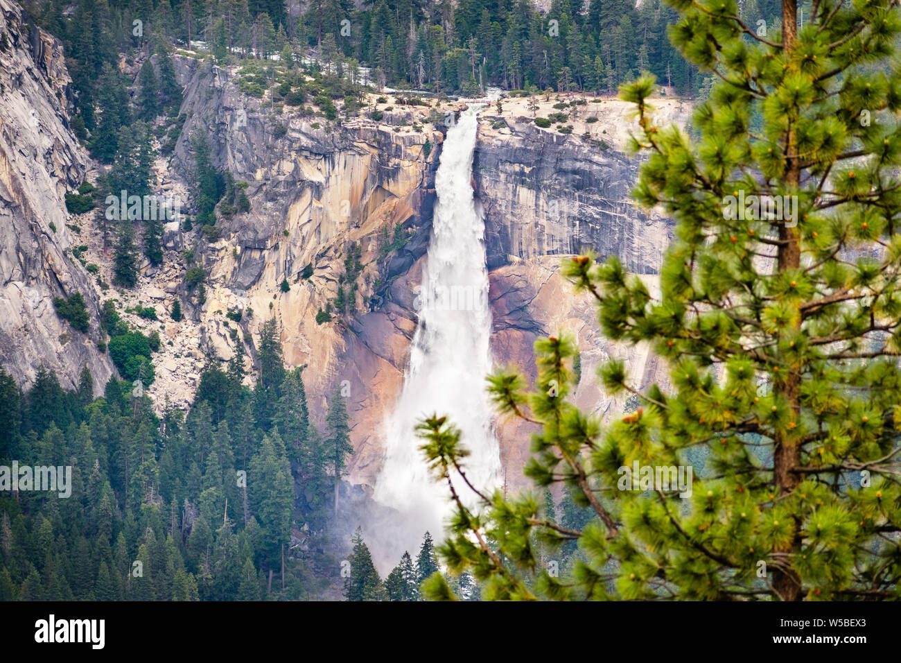 Aerial view of Nevada Fall, Yosemite National Park, Sierra Nevada mountains, California; People visible on the hiking trail on the left and above the Stock Photo