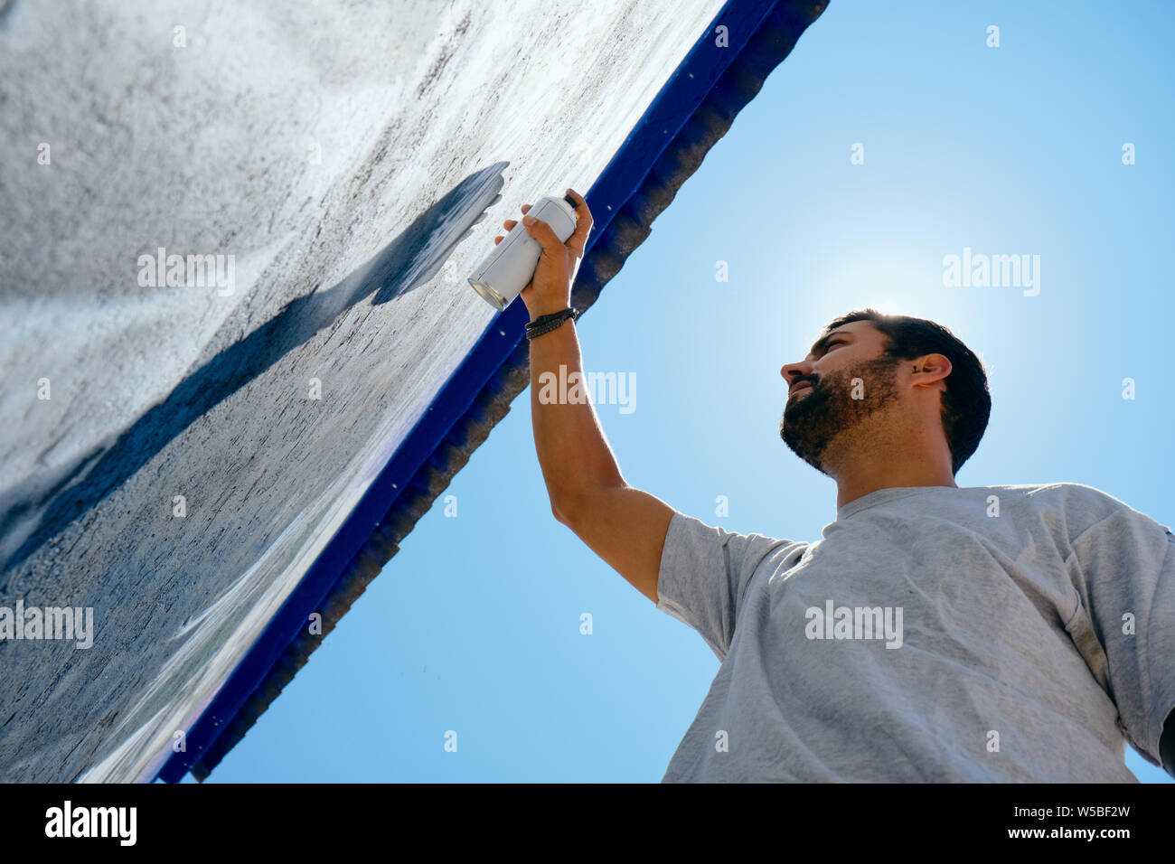 Man Painting Graffiti Along The Camino de Santiago Stock Photo