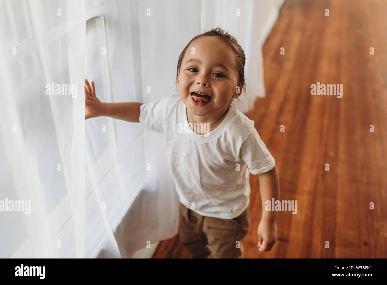Portrait of young boy looking at camera laughing in a studio Stock ...