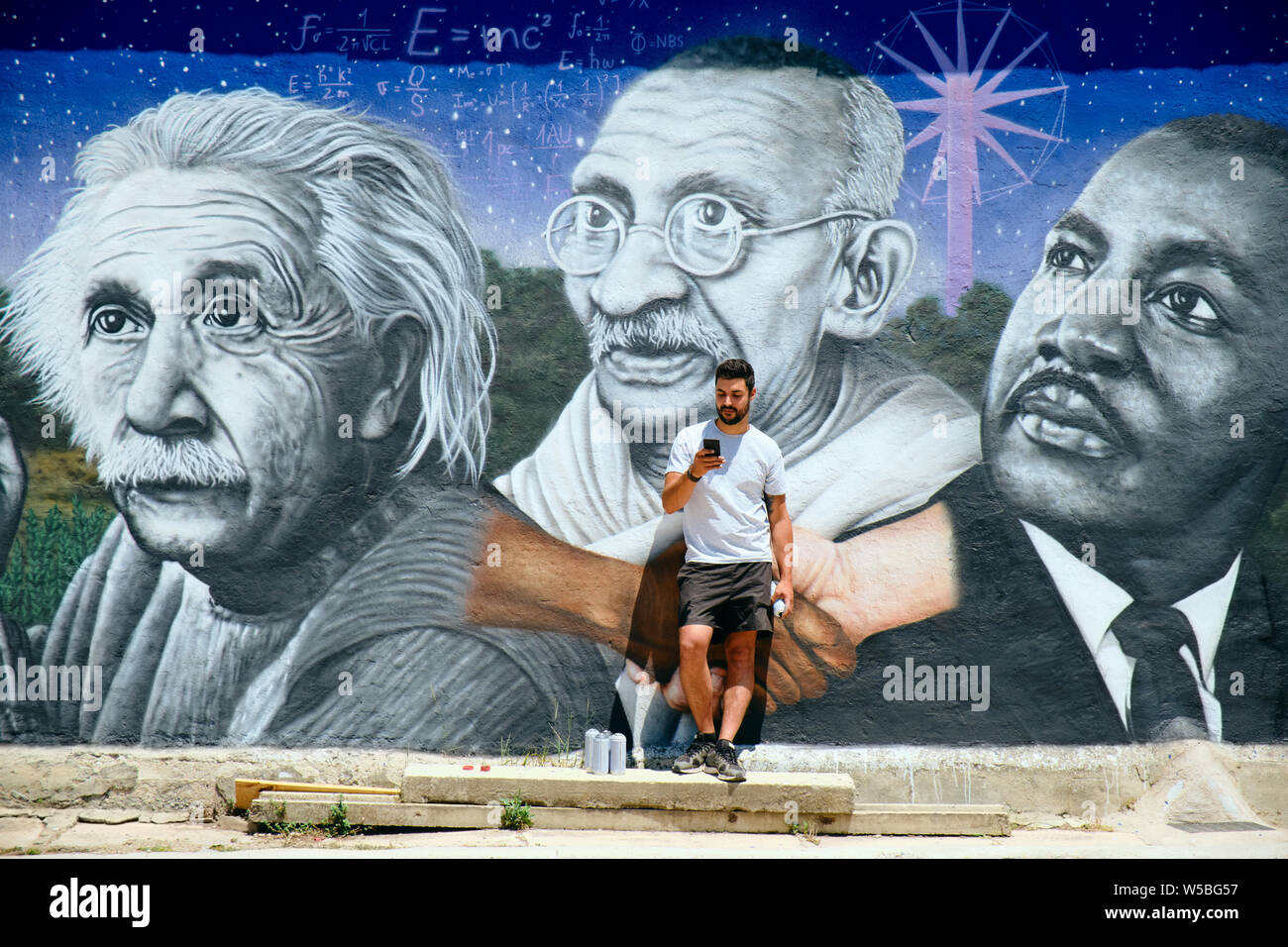 Man Painting Graffiti Along The Camino de Santiago Stock Photo