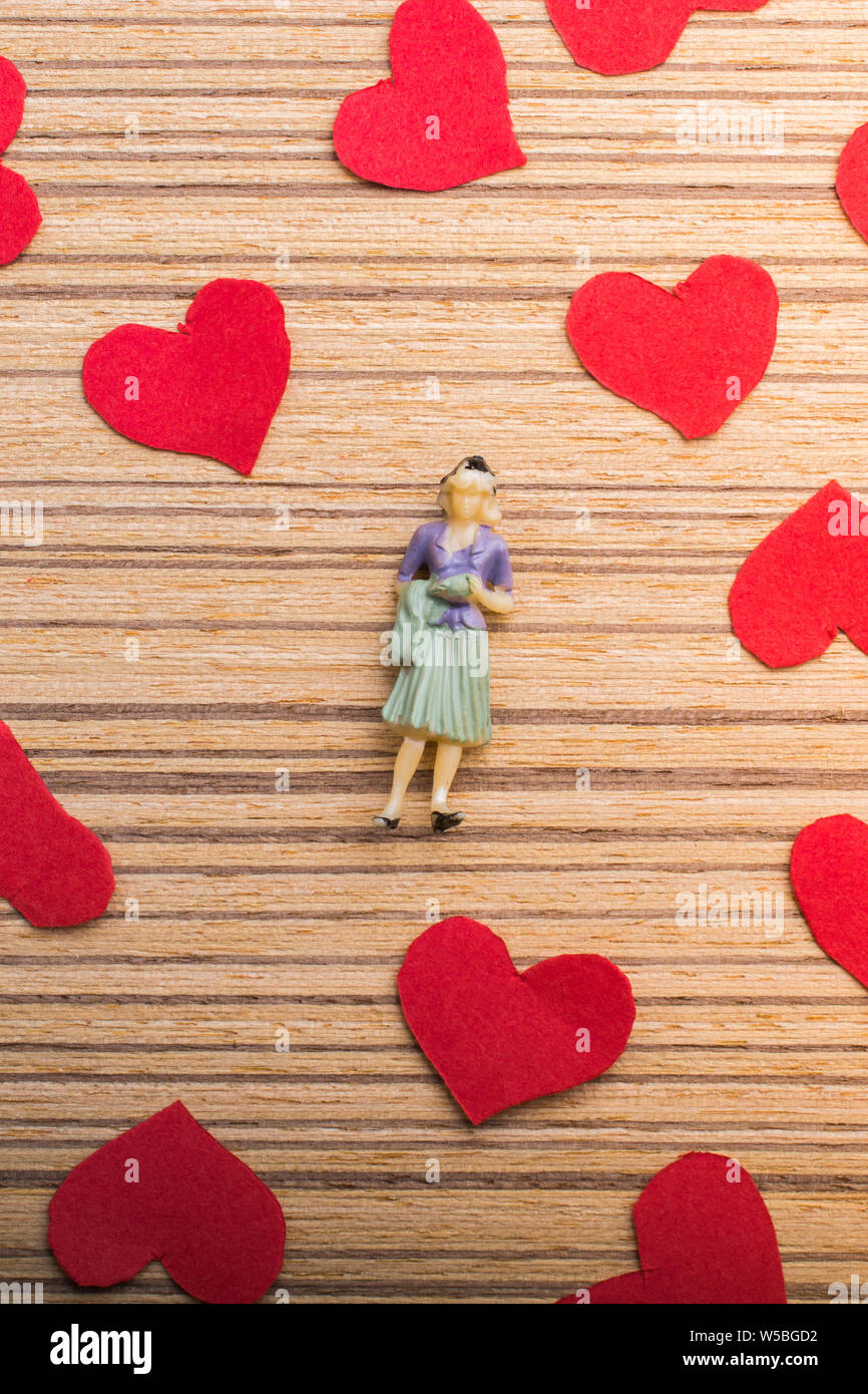 Woman figurine and Love concept with red paper hearts Stock Photo - Alamy