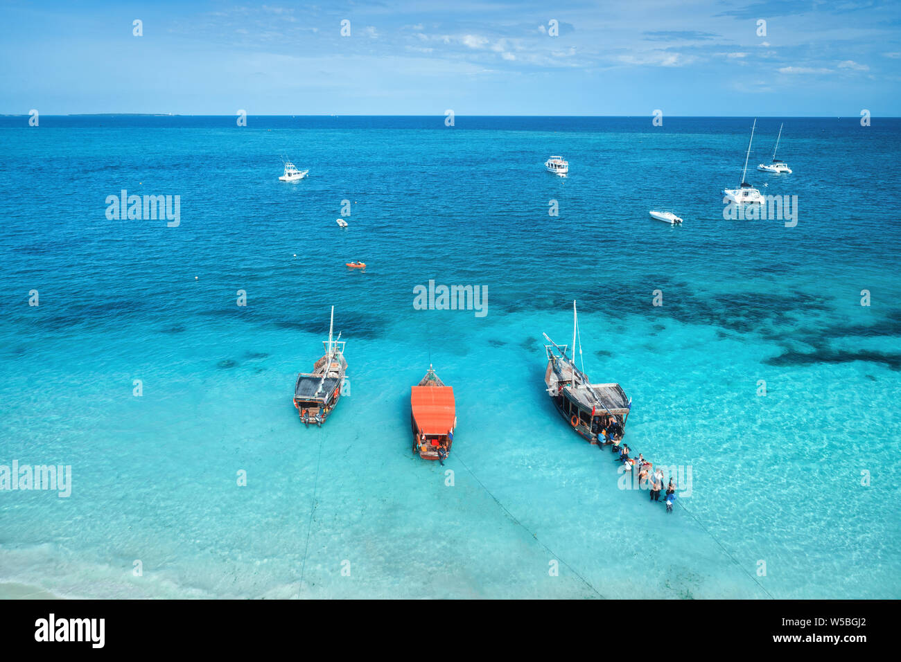 Aerial view of the yachts, fishing boats in transparent blue sea at ...