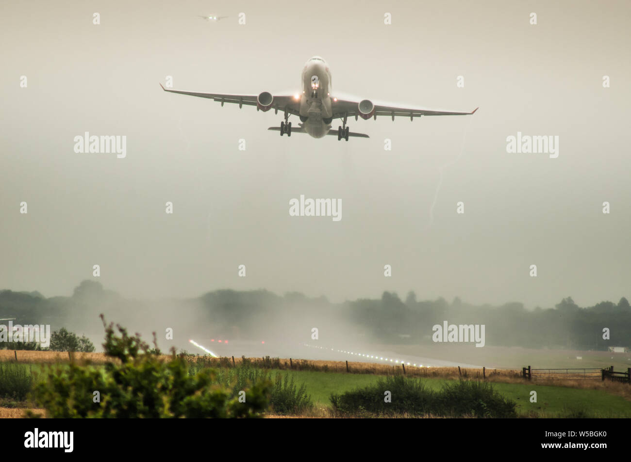 Gatwick Airport, Horley, West Sussex, UK.. 27th July 2019..Getting back to normal, busy,  operations in  heavy rain after record heat & lightning storms created havoc in the UK transport systems. . Stock Photo