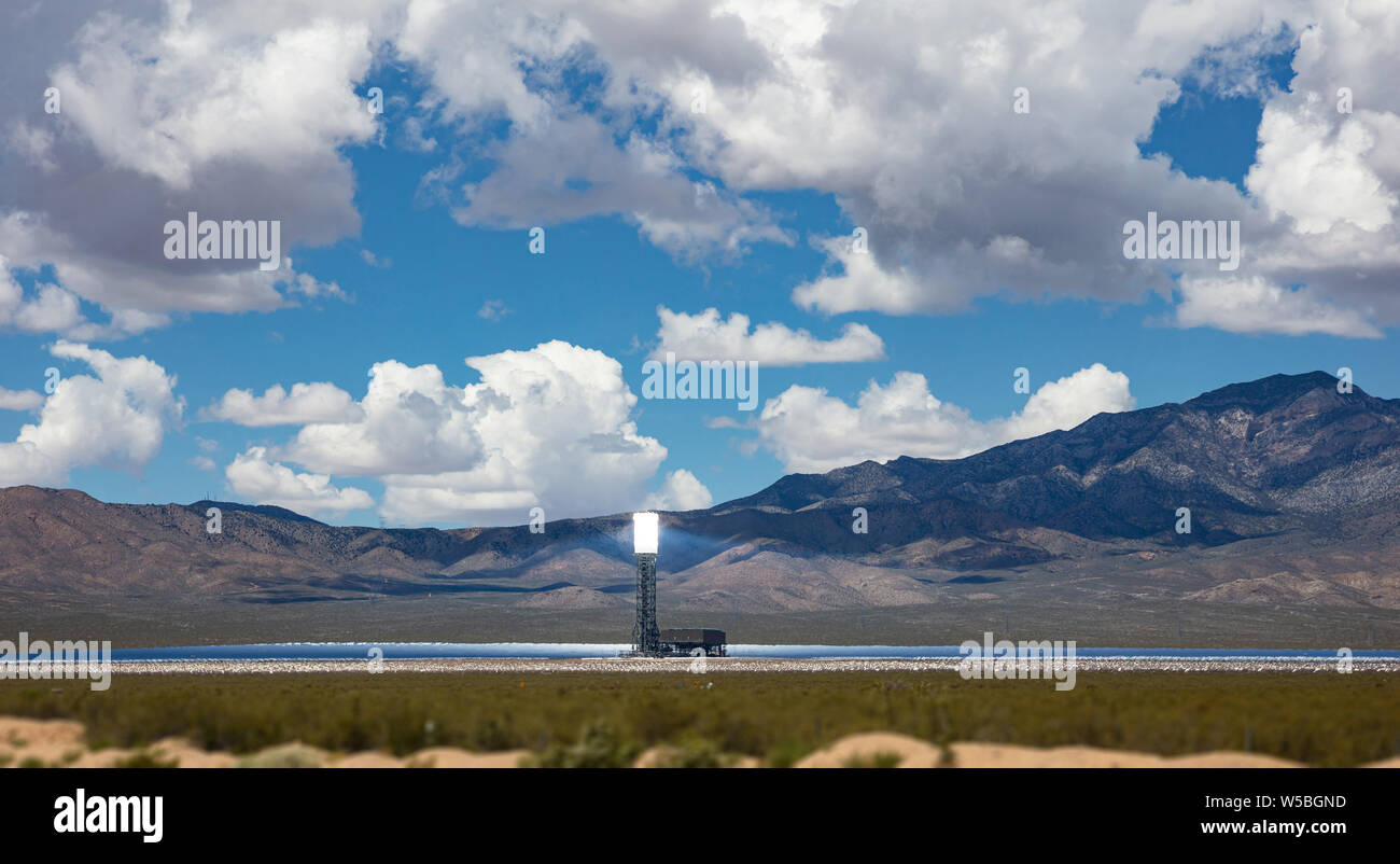Concentrated solar power plant, CSP. Tower and mirrors, solar thermal energy, Blue sky with clouds, spring day in desert, United States Stock Photo