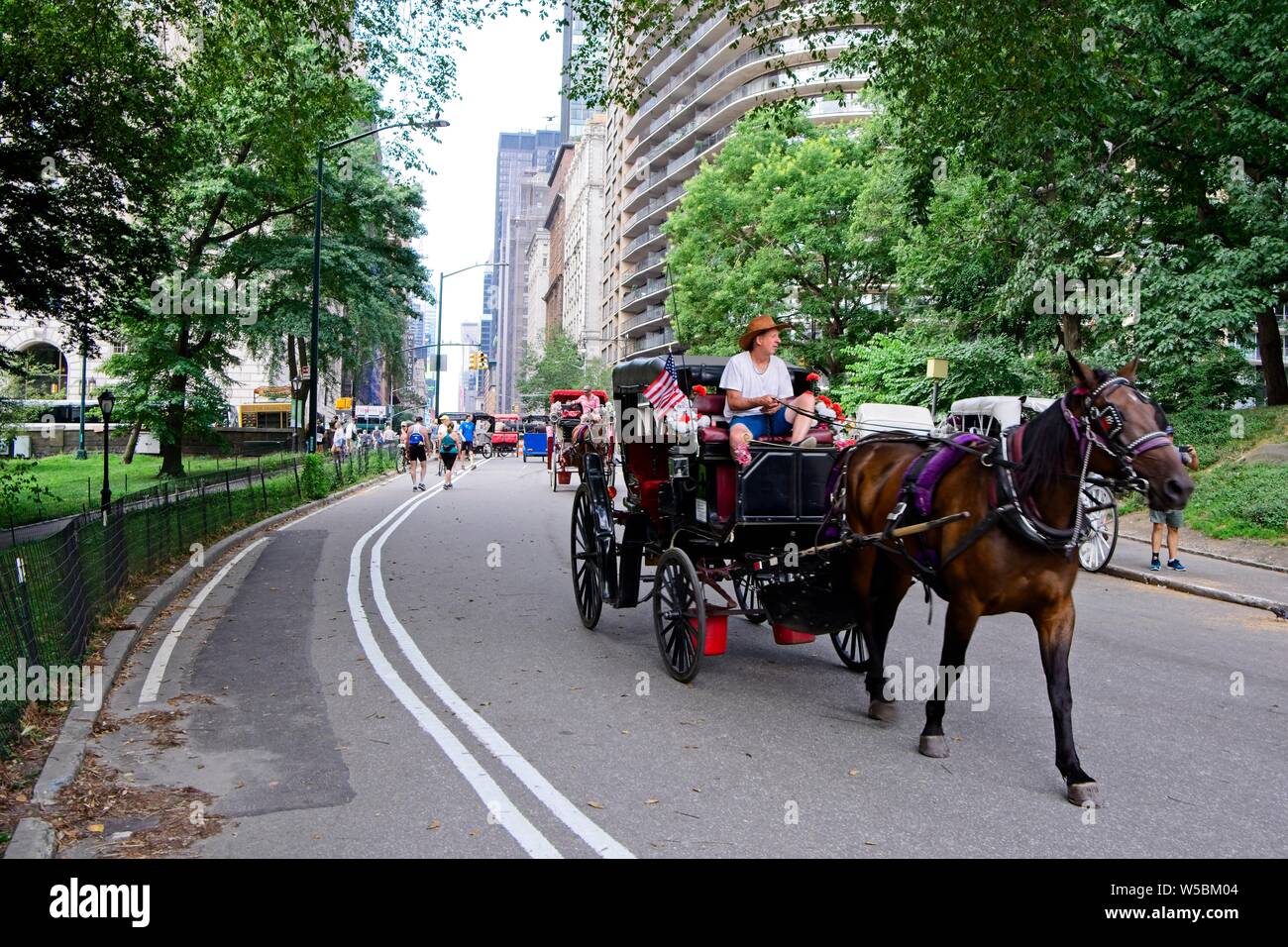 Central Park NYC carriages and pedicabs Stock Photo - Alamy