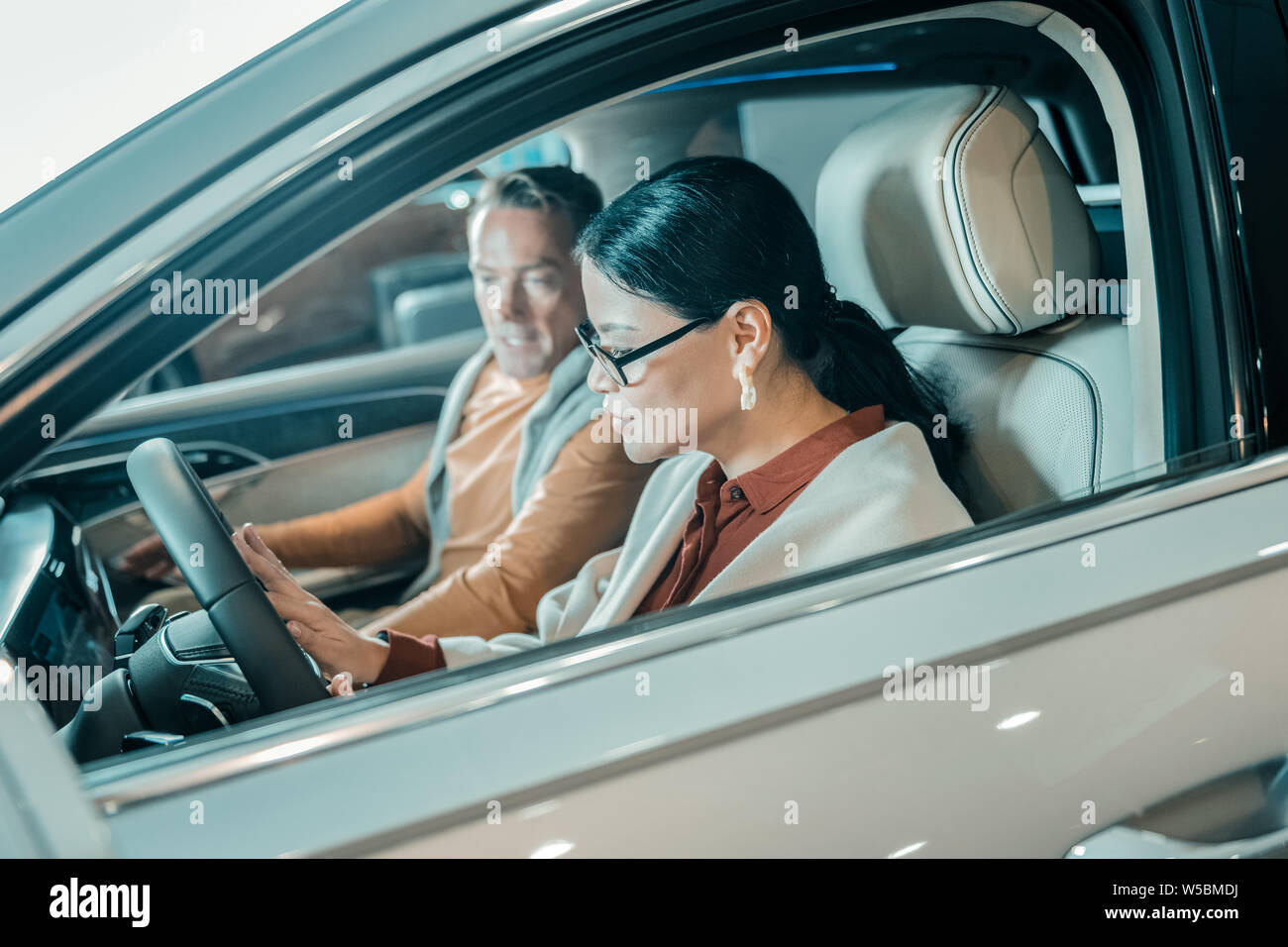 Woman sitting at the wheel of a new car Stock Photo - Alamy