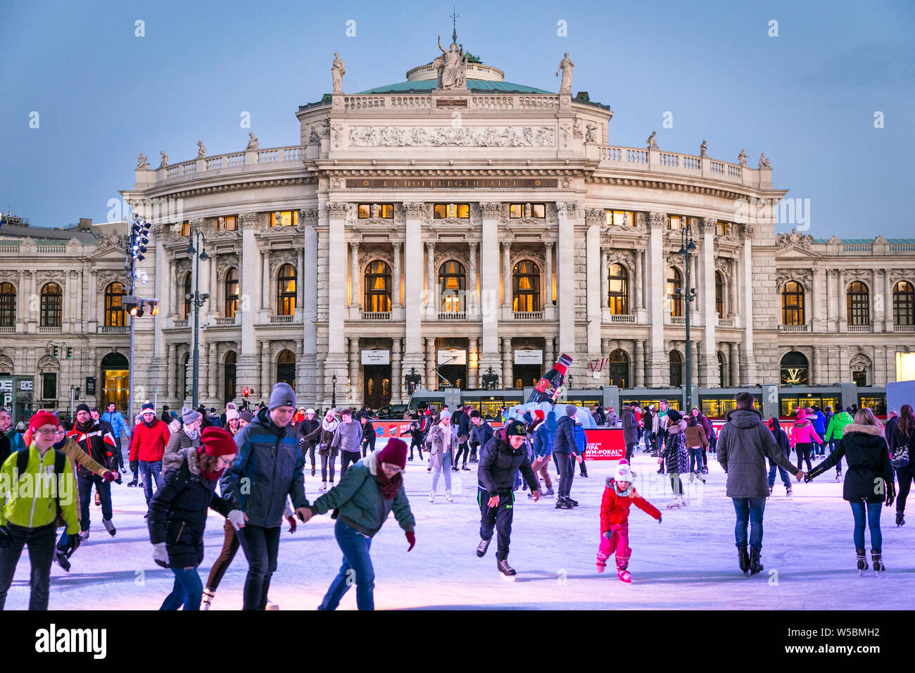 Crowd of people skating in front of Rathausplatz which is transformed