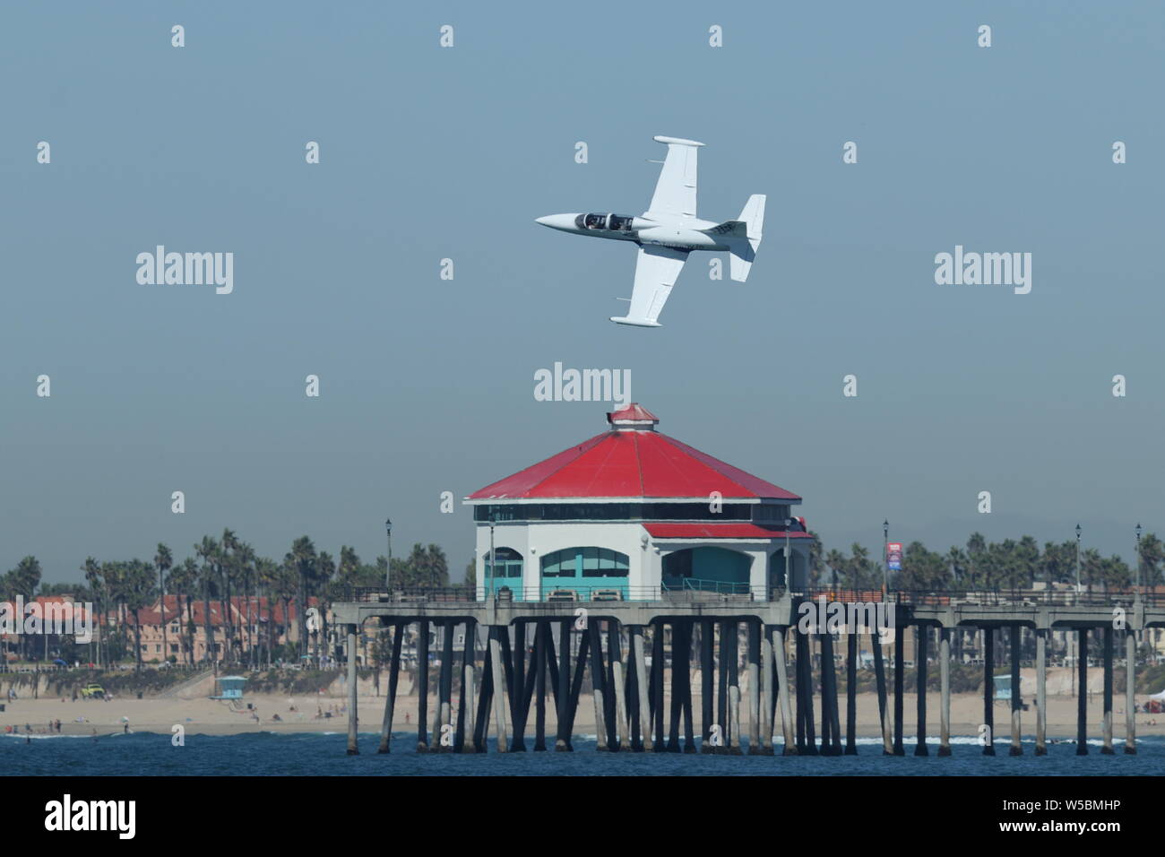 Aero L-39 Albatros flies over Ruby's Surf City Diner on the pier during the Great Pacific Airshow in Huntington Beach, California on October 19, 2018 Stock Photo