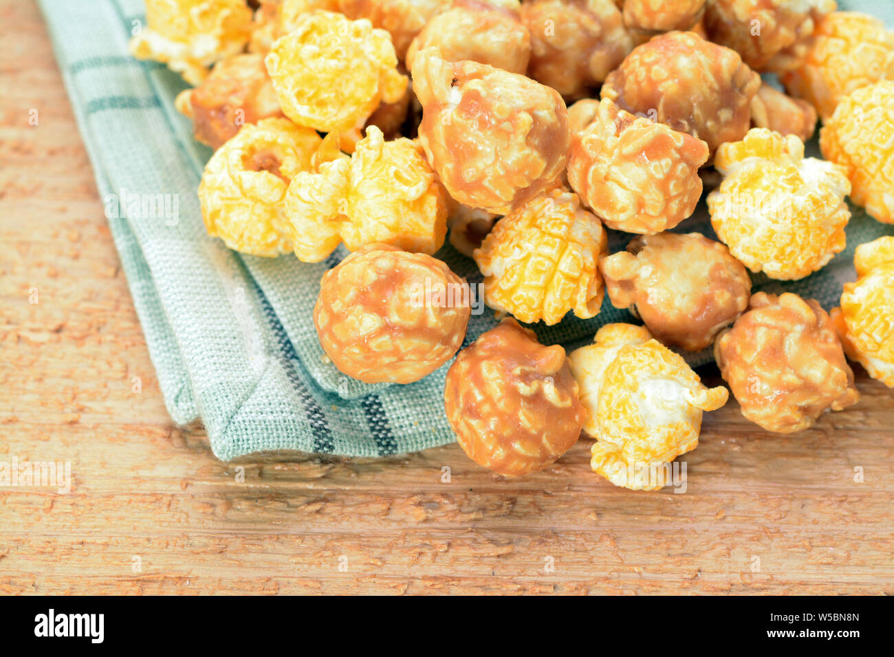 Caramelized popcorn on table Stock Photo