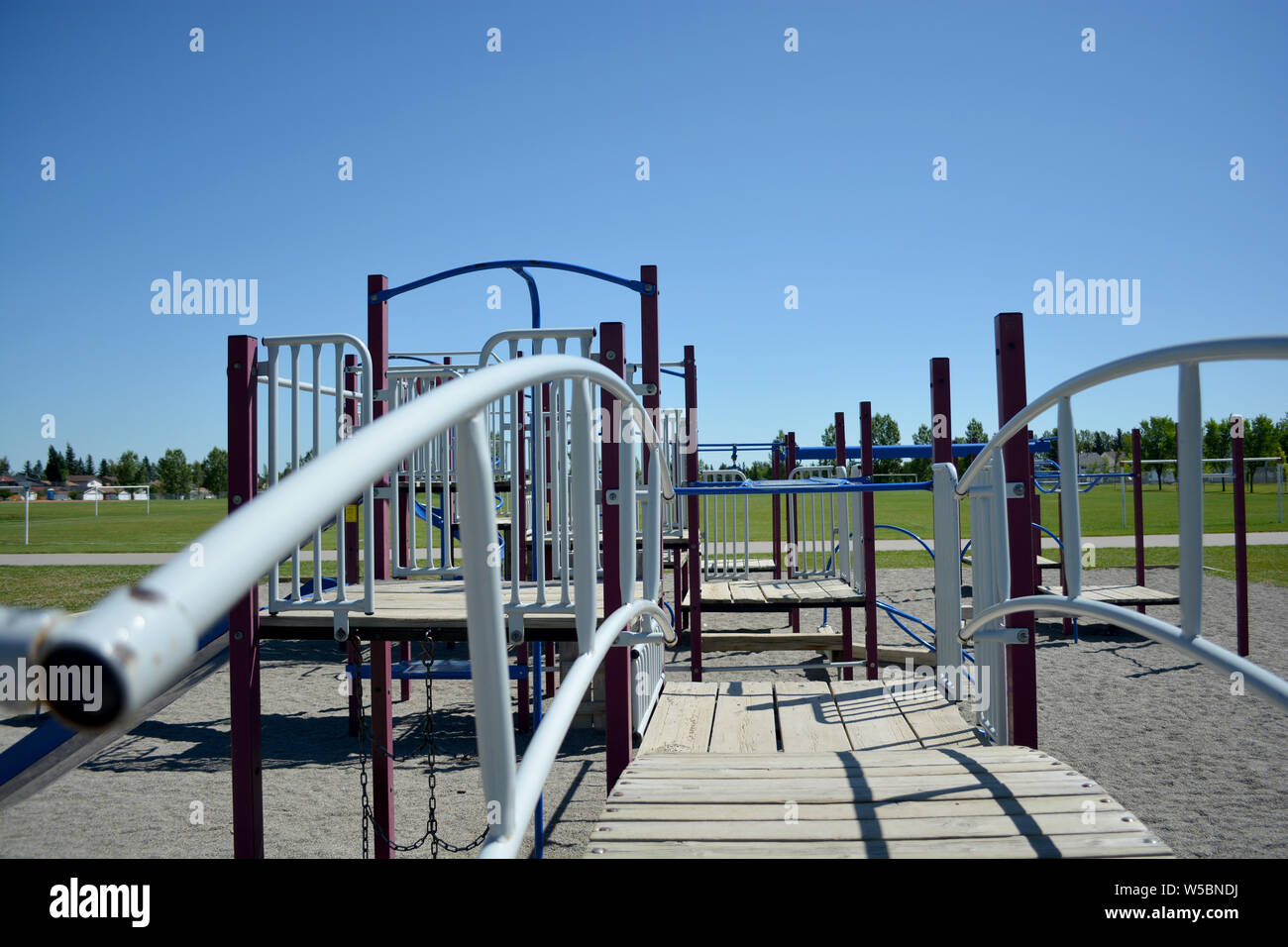 Colourful playground bridge and hand rail in school yard. Stock Photo