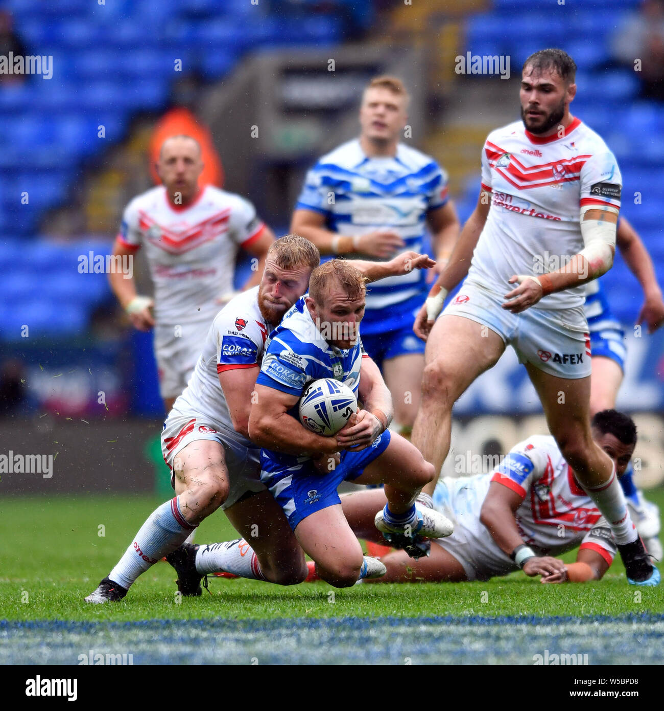 Bolton, UK. 27th July, 2019. Coral Challenge Cup Semi Final St Helens versus Halifax; Brandon Moore of Halifax RLFC is eventually tackled by Luke Thompson of St Helens Credit: Action Plus Sports Images/Alamy Live News Stock Photo
