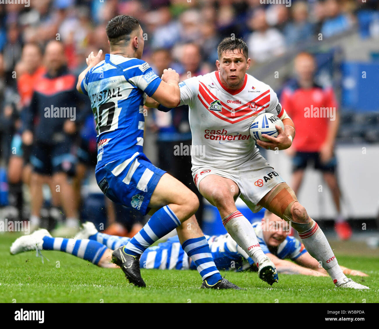 Bolton, UK. 27th July, 2019. Coral Challenge Cup Semi Final St Helens versus Halifax; Louis McCarthy-Scarsbrook of St Helens attempts to side step the tackle from James Saltonstall of Halifax RLFC Credit: Action Plus Sports Images/Alamy Live News Stock Photo
