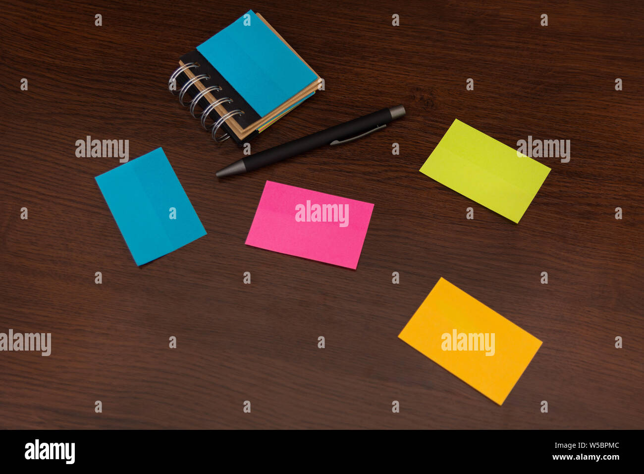 Colorful sticky notes and pen on brown wooden desk. Top view and space for  text. Close up, selective focus Stock Photo - Alamy