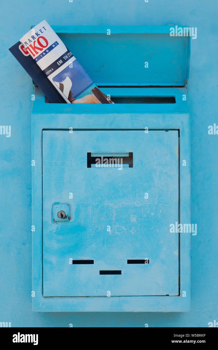 Mailbox with magazine, journal inside of it. Postal service concept. Safety of personal data background. Mail drop with newspaper, magazine. Mail doors background. Advertising concept Stock Photo