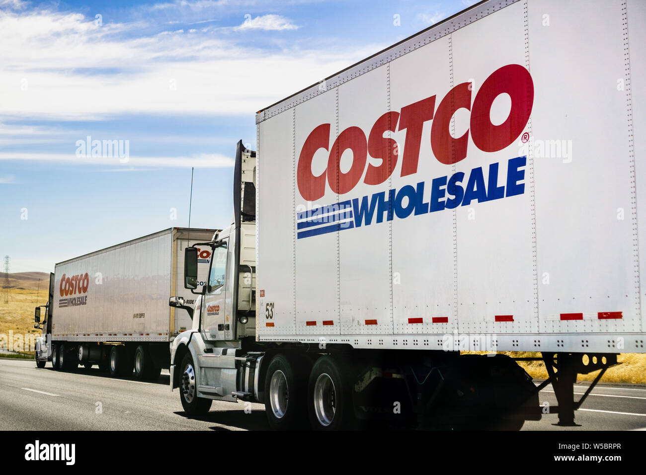 June 28, 2019 Stockton / CA / USA - Branded Costco Wholesale trucks driving on the freeway Stock Photo
