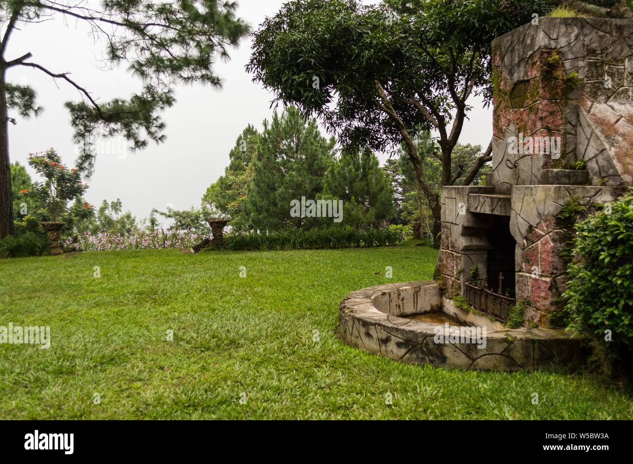 SAN SALVADOR, EL SALVADOR - Jul 26, 2019: View of a red brick chimney that has been abandoned outdoors Stock Photo