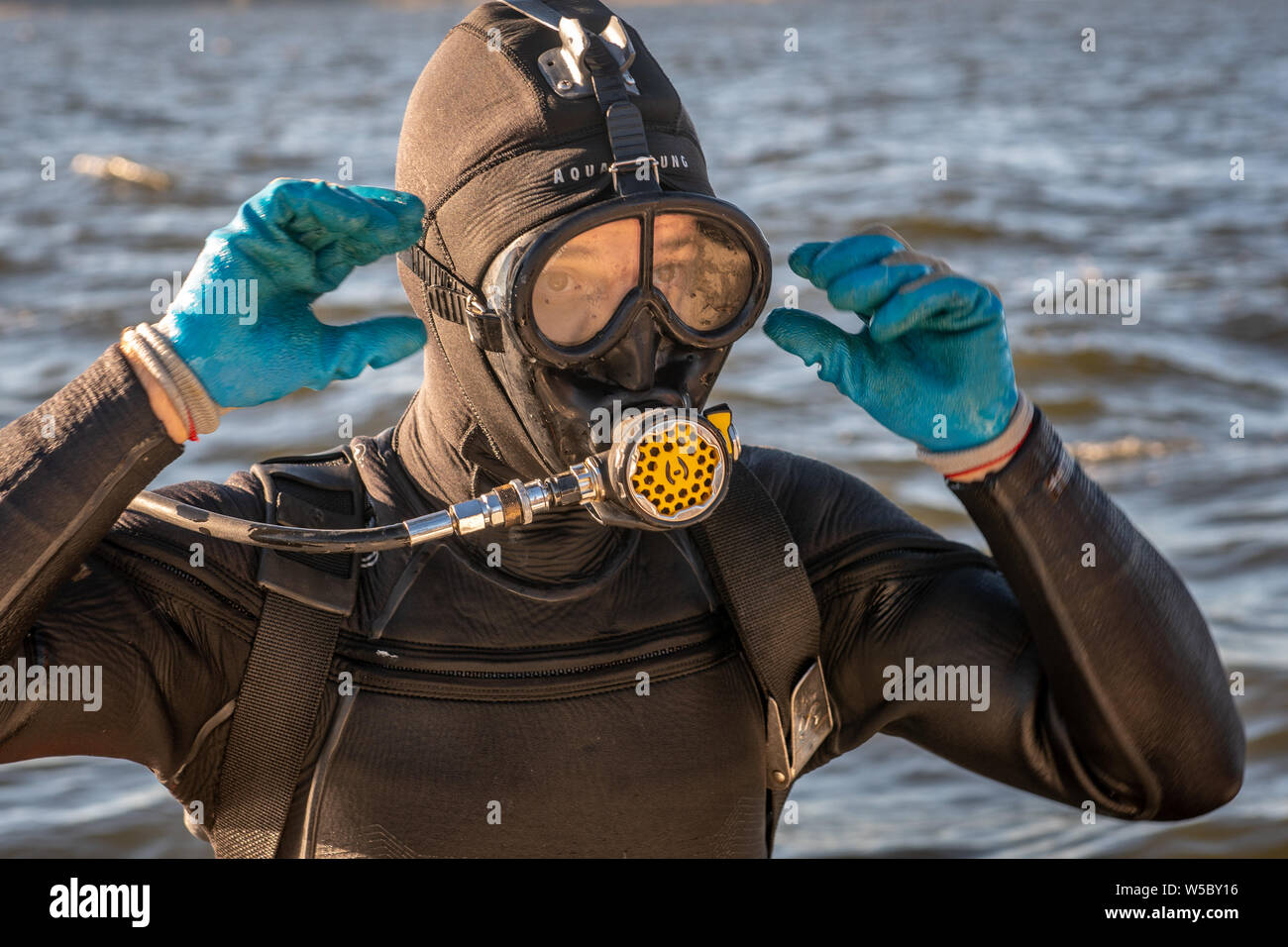 A wild oyster diver prepares and checks his gear before a dive, Wittman