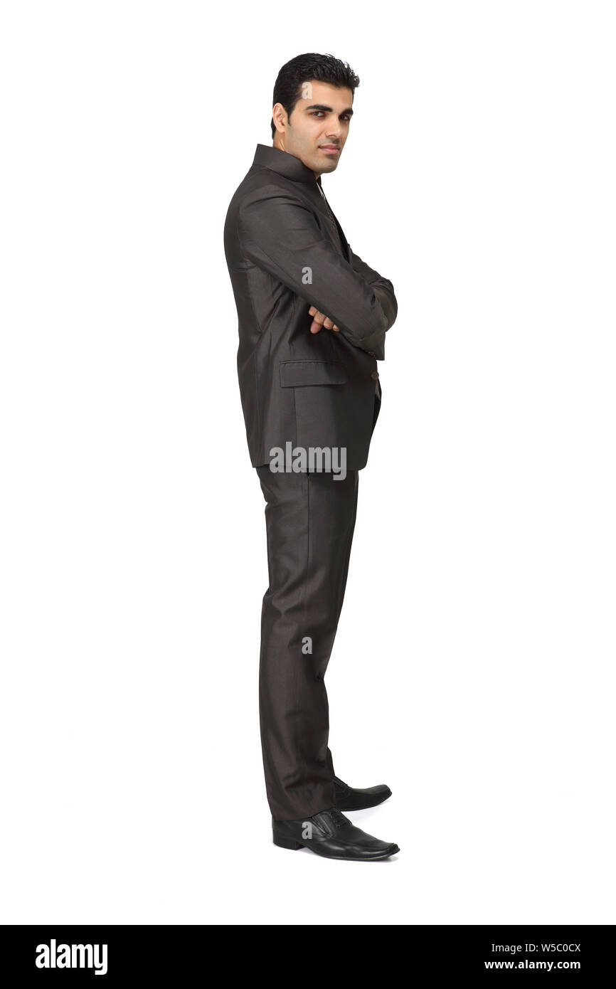 Indian businessman standing with his arms crossed Stock Photo - Alamy