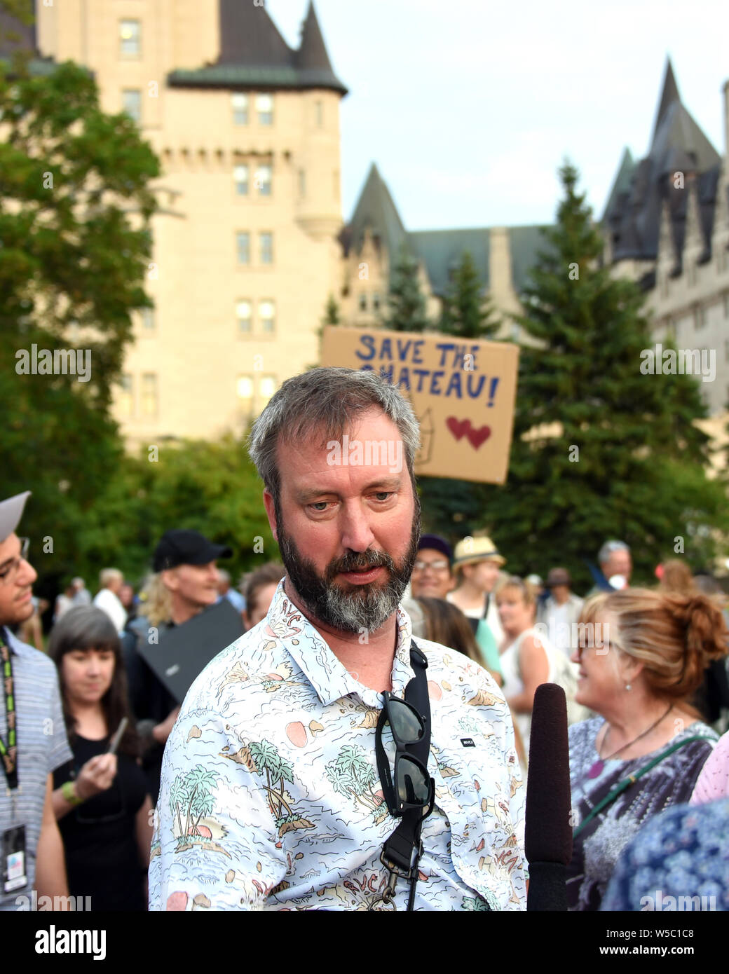 Ottawa, Canada - July 27, 2019:  Ottawa born comedian Tom Green at the rally he invited the public to join in an effort to prevent a proposed addition to the Chateau Laurier that many people feel is not appropriate for the iconic hotel as seen in the background.  He has been raising awareness for the issue on social media. Stock Photo