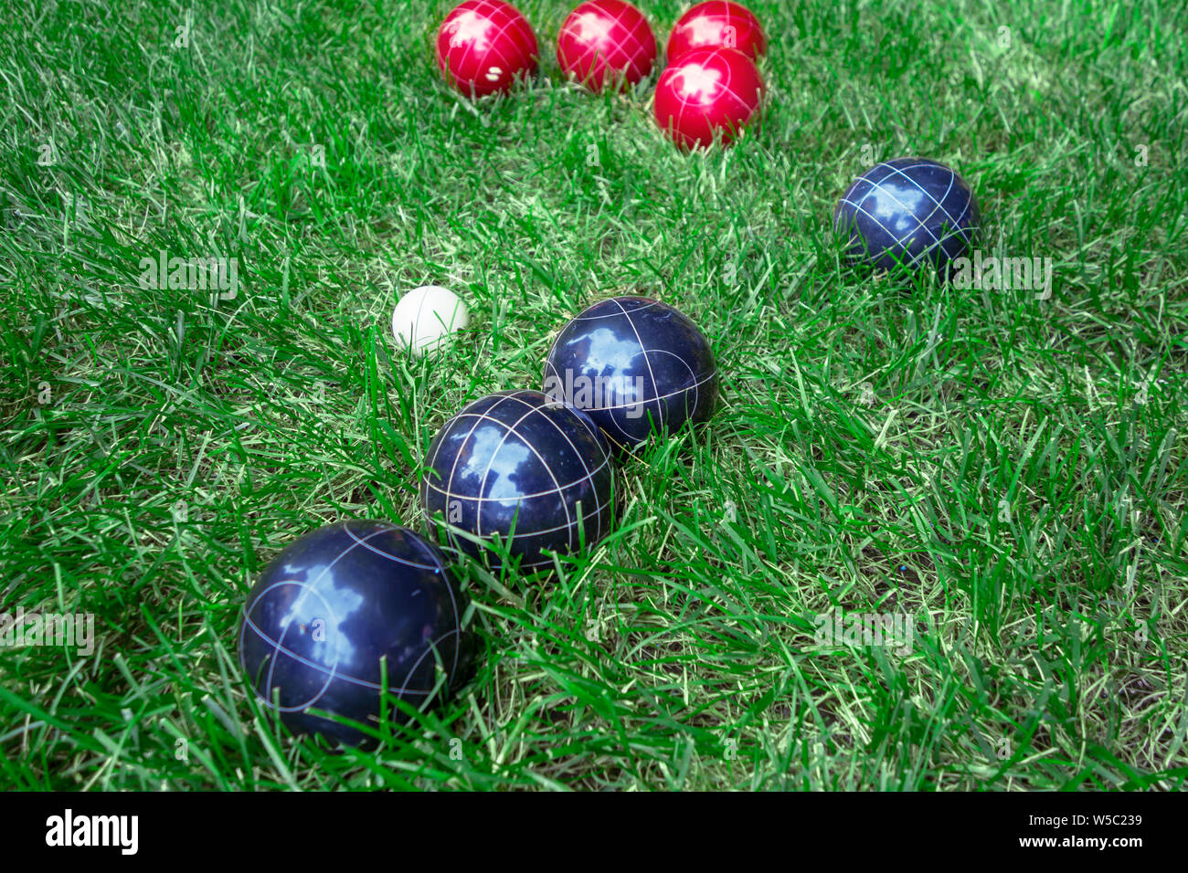 Red, white and blue european bocci balls on green lawn Stock Photo
