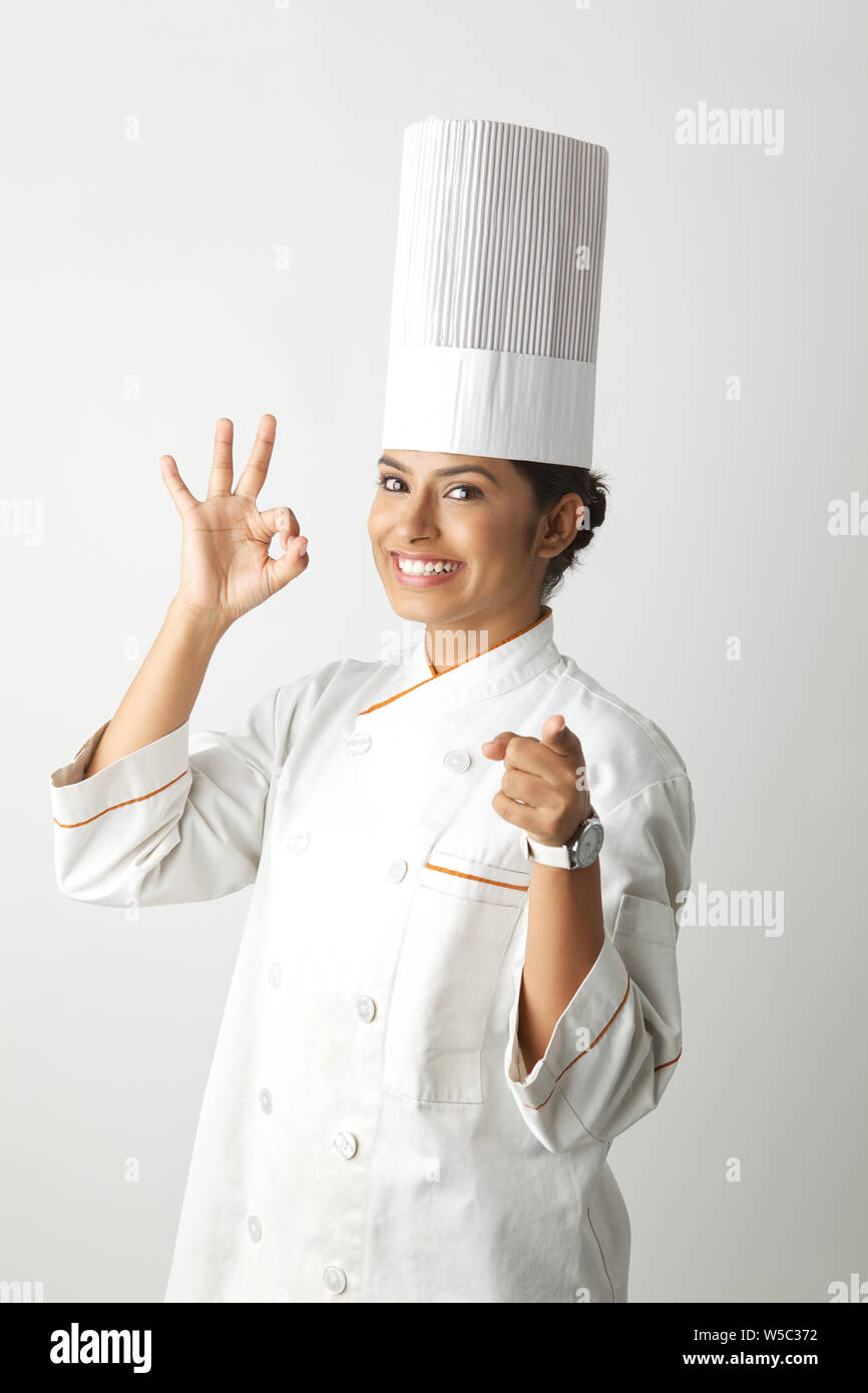Chef showing ok sign and pointing Stock Photo
