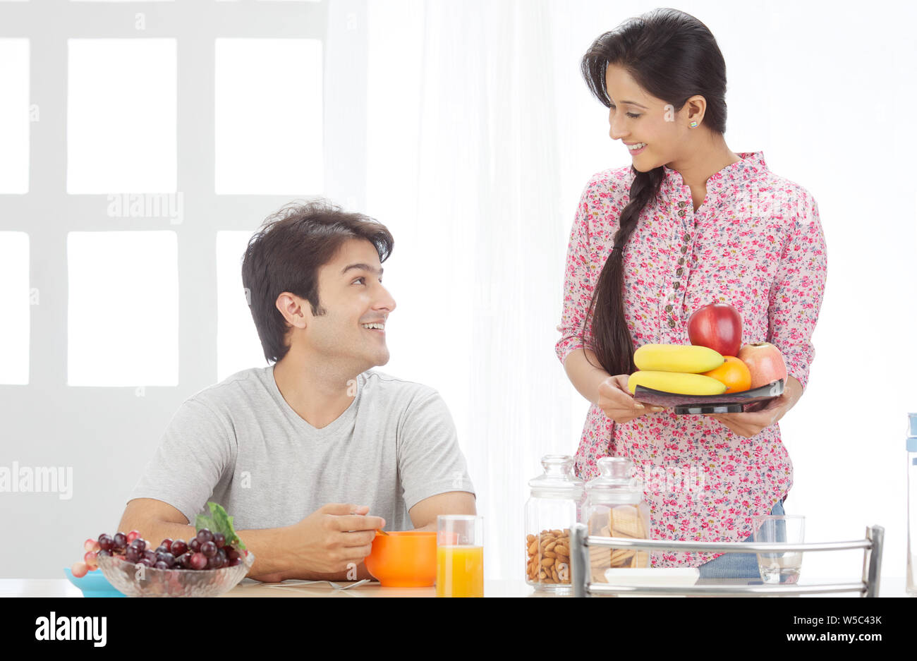 Indian man serving juice wife hi-res stock photography and images - Alamy