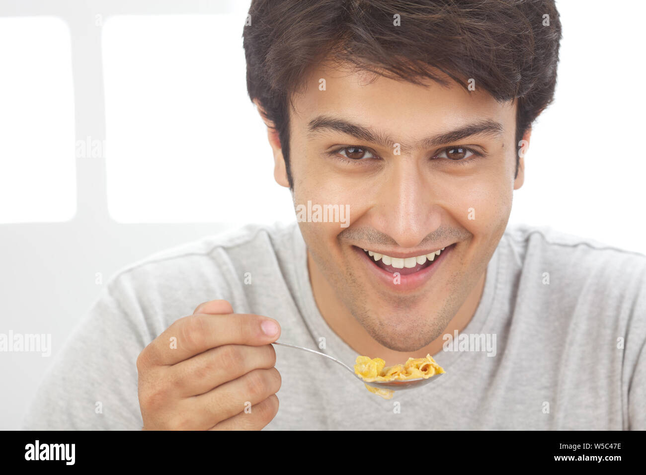 Man eating cornflakes Stock Photo Alamy