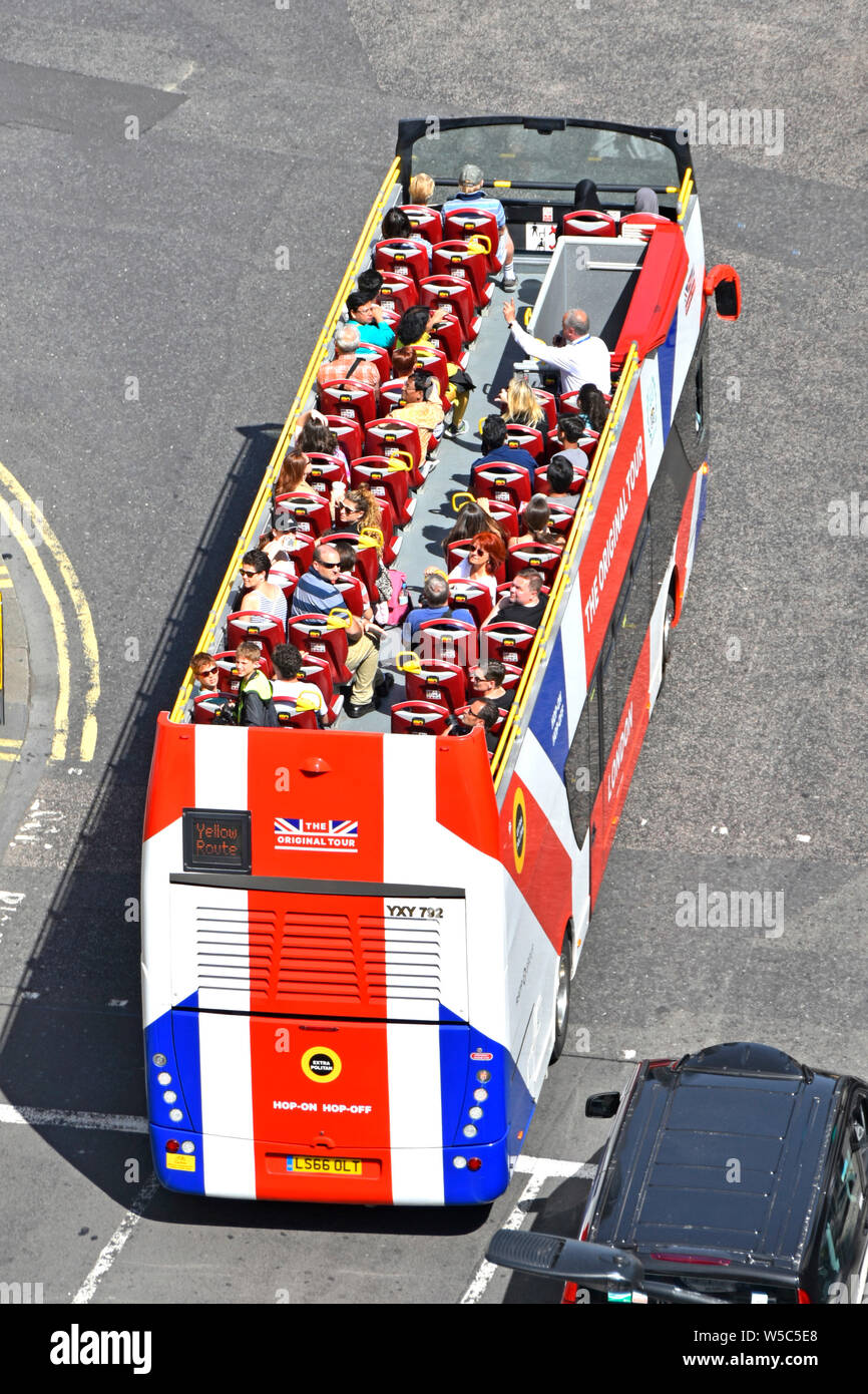 Aerial birds eye view of London street scene looking down at people from high above on London open top double decker sightseeing tour bus England UK Stock Photo