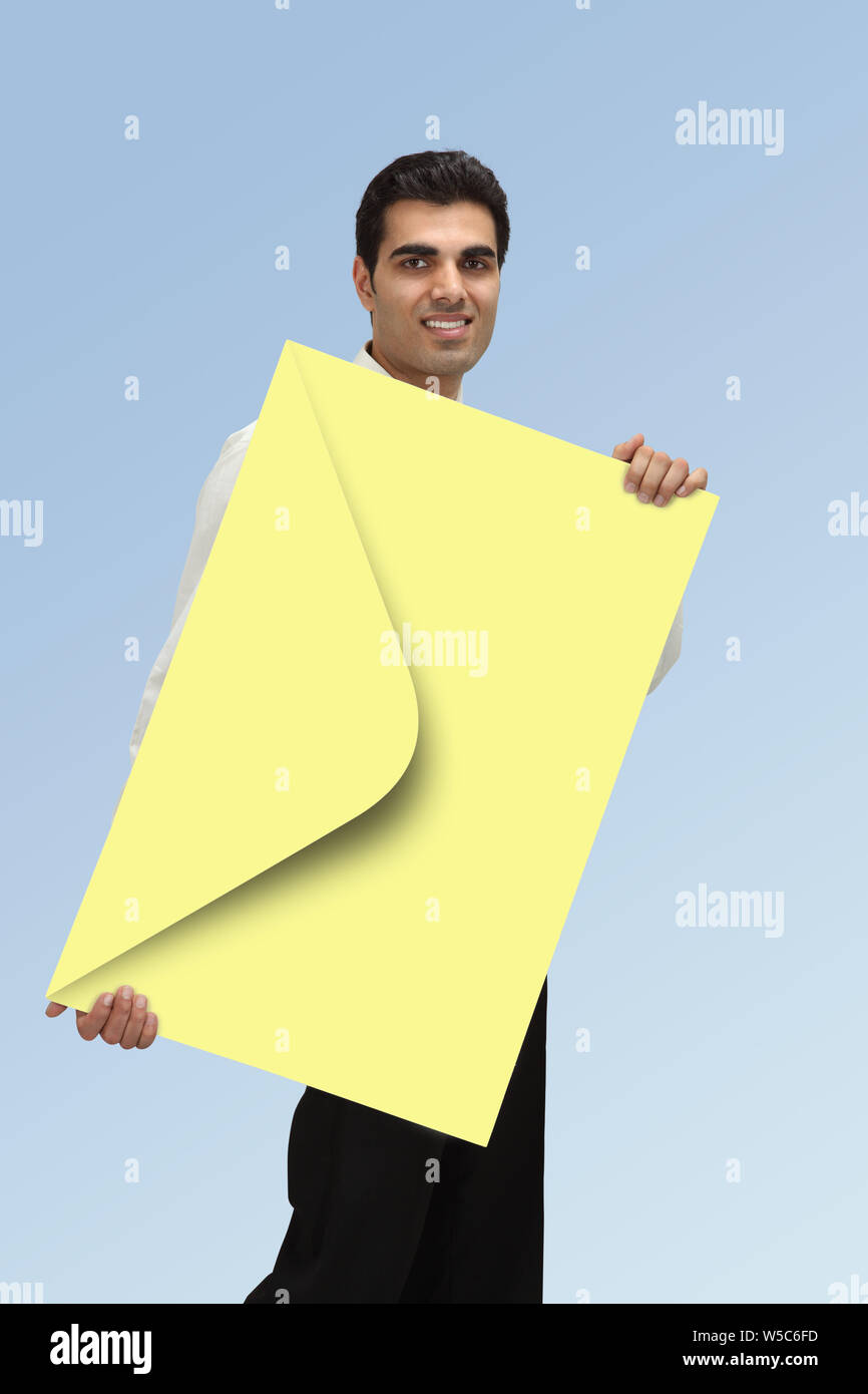 Man with big envelope in hand Stock Photo Alamy