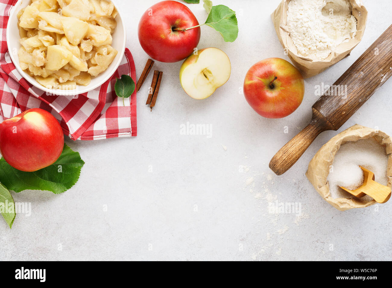 Ingredients and tools for making an apple pie. Seasonal sweet pastry background with copy space. Stock Photo