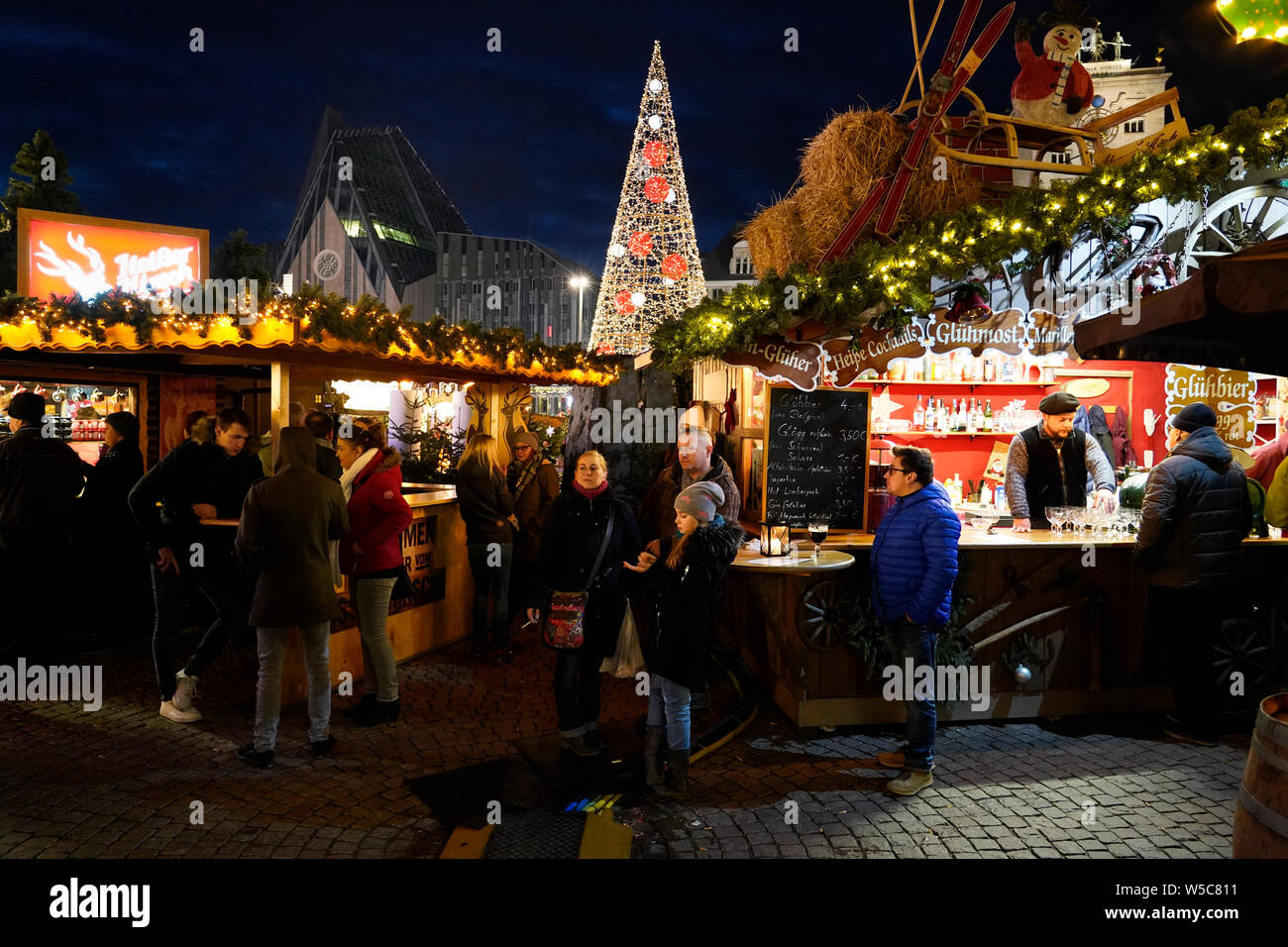 People drinking mulled wine at the Christmas market in the city center. Augustusplatz, Leipzig, Saxony, Germany, Europe Stock Photo