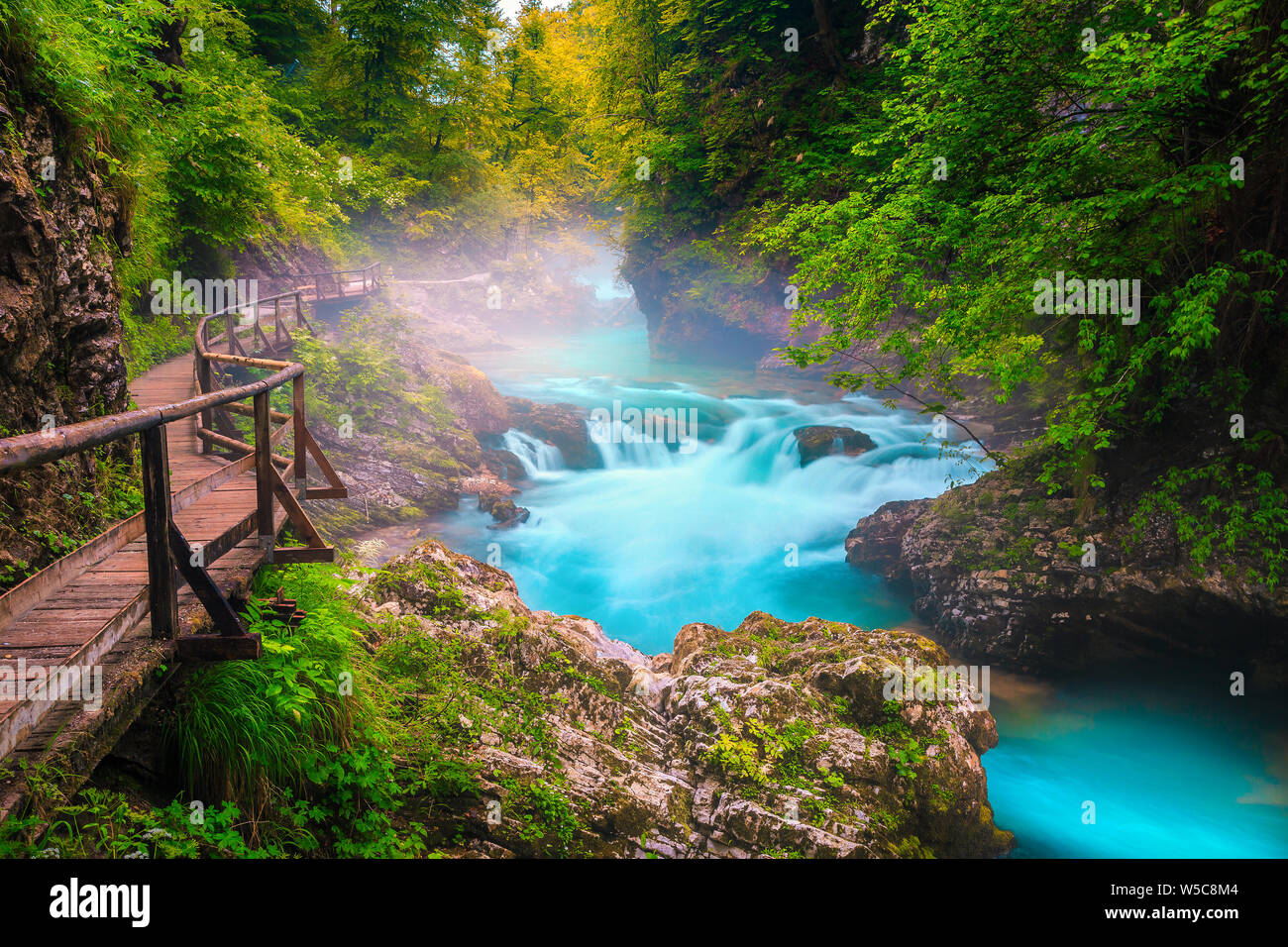 Fantastic and well known touristic attraction near Bled. Wonderful Vintgar gorge with wooden footbridge and emerald color Radovna river, near Bled, Go Stock Photo