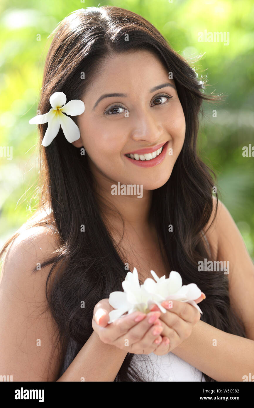 Portrait of a woman holding a flower Stock Photo
