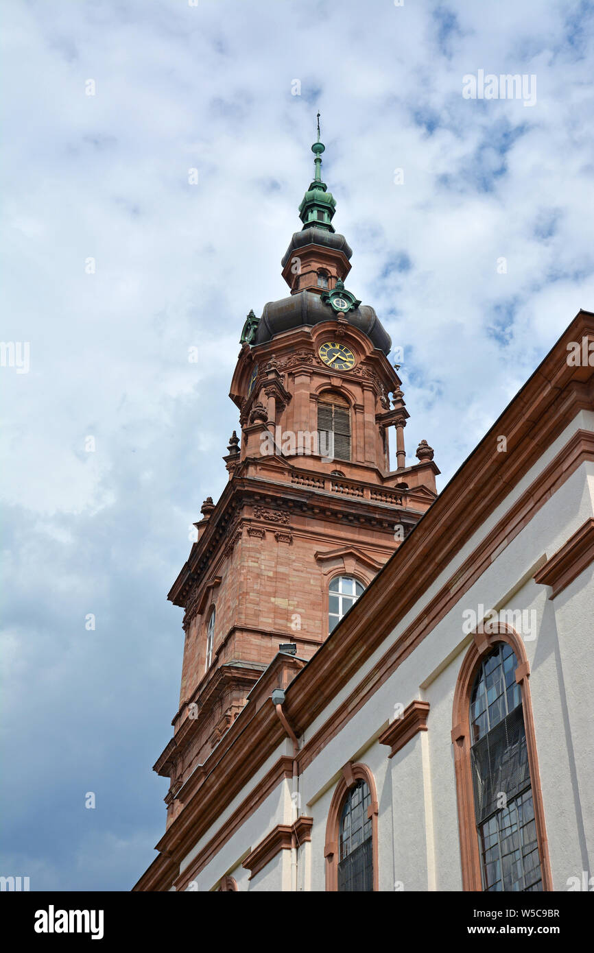 Clock tower of German city chucrh called 'CityKirche Konkordien' in city of Mannheim in front of cloudy summer sky Stock Photo