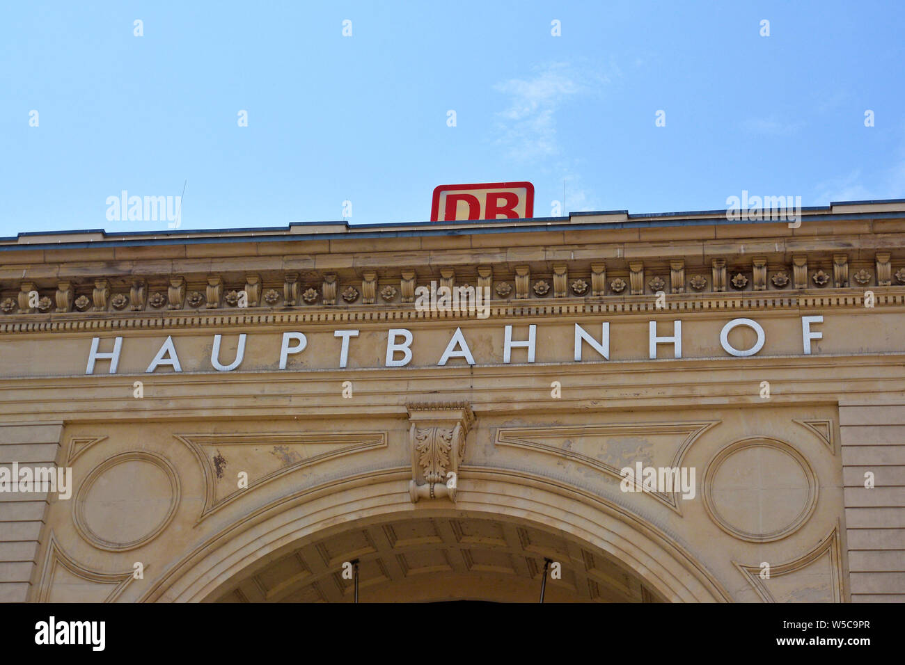 Mannheim, Germany - July 2019: Facade of German main station and 'Deutsche Bahn' train company logo above Stock Photo