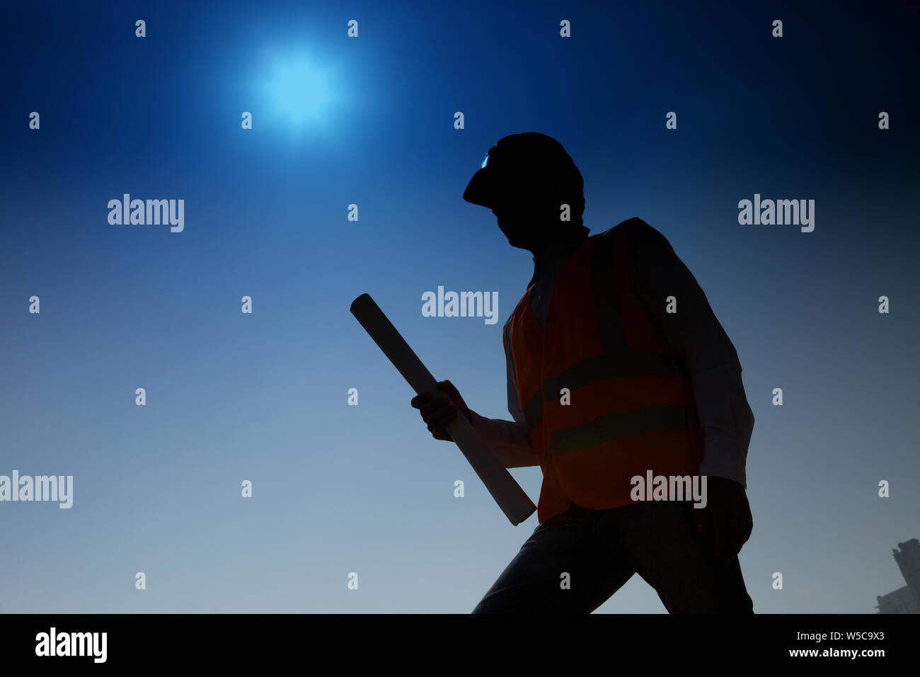 Architect holding blueprint at construction site Stock Photo - Alamy