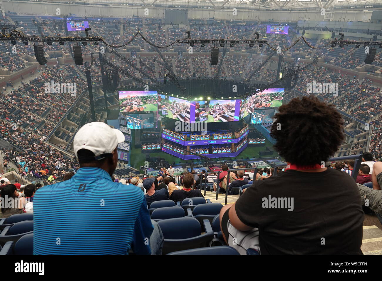 New York, USA. 27th July, 2019. Spectators follow the Fortnite World Cup at the Arthur Ashe Tennis Stadium. At the World Cup almost 200 young people will fight for prize money of 30 million dollars. Credit: Benedikt Wenck/dpa/Alamy Live News Stock Photo