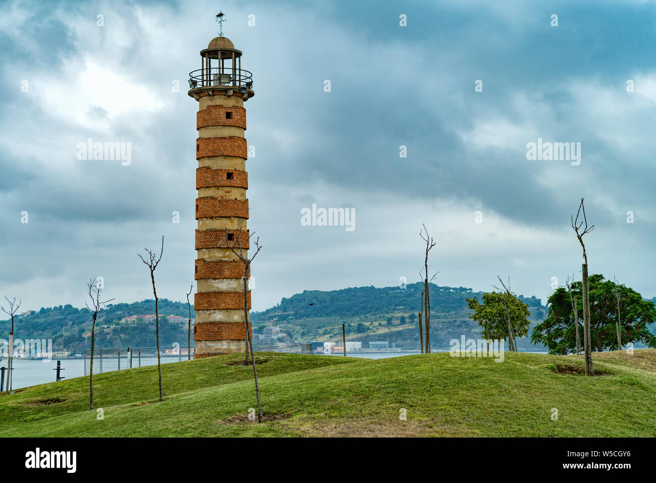 Brick ringed lighthouse set in a landscaped garden by the Tagus River , Belém, Lisbon, Portugal, Europe. Stock Photo